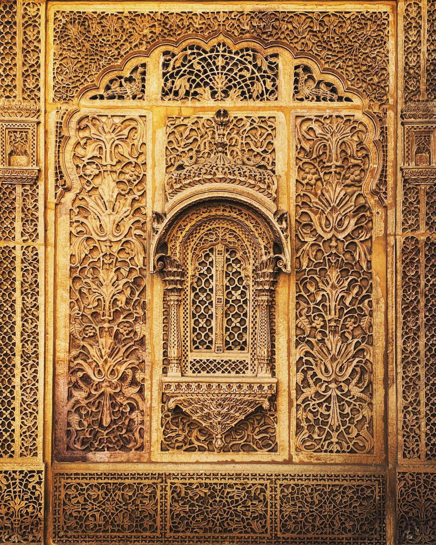 Detailed carved architectural facade around a central arch.