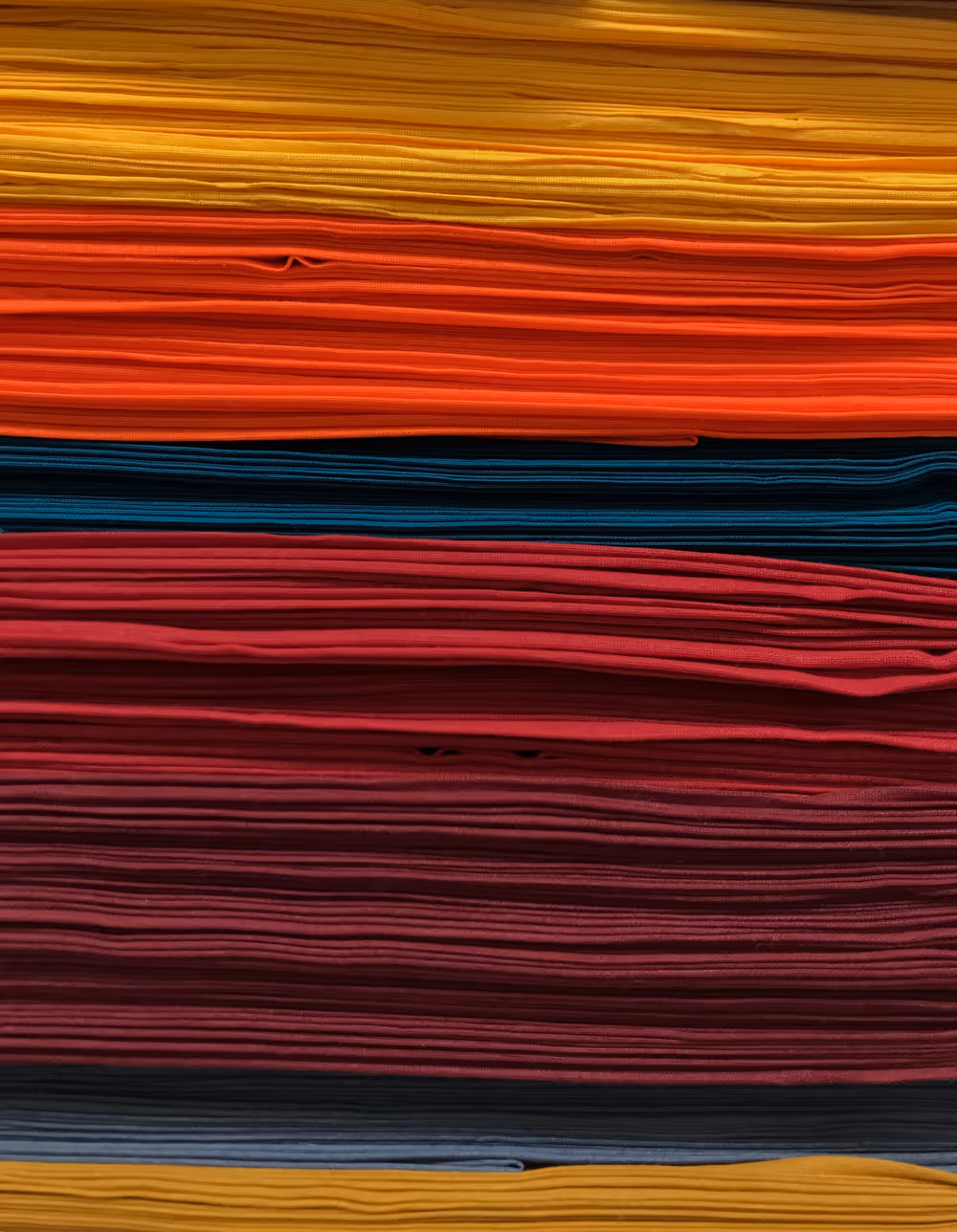 Layered red, blue, and black textile-like bands.